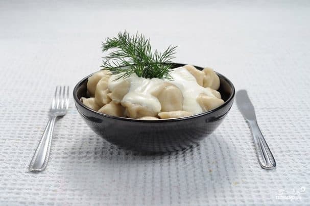 Pelmeni in a pot with milk