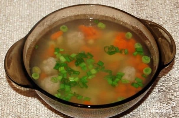 Soup with meatballs and peas