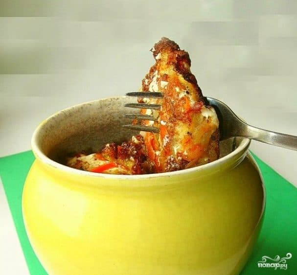 Potato pancakes in a pot with mushrooms