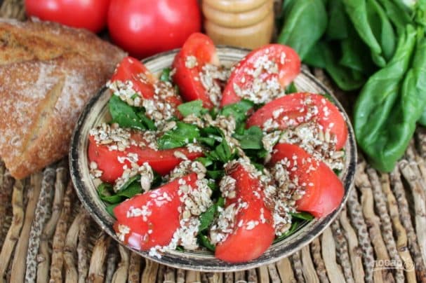 Tomato salad with sesame, sunflower seeds, and flaxseeds