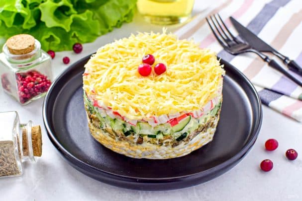 Salad with crab sticks, cucumbers, and mushrooms