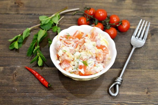 Salad with crab sticks, tomatoes, and cheese