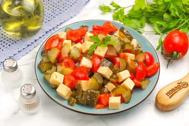 Salad with cheese, tomatoes, and pickled cucumbers