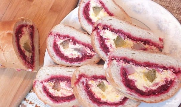 Herring under a fur coat in a baguette