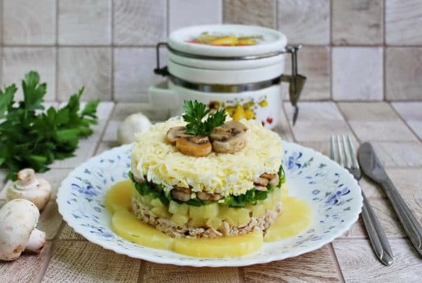 Layered salad with pineapples, chicken, and fried mushrooms